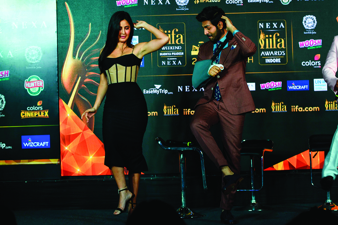 Bollywood actors Katrina Kaif (L) and Kartik Aaryan dance on stahe as they attend the International Indian Film Academy (IIFA) press Conference for the 21st Edition of NEXA IIFA Weekend &amp; Awards 2020, in Mumbai on March 4, 2020. (Photo by INDRANIL MUKHERJEE / AFP)