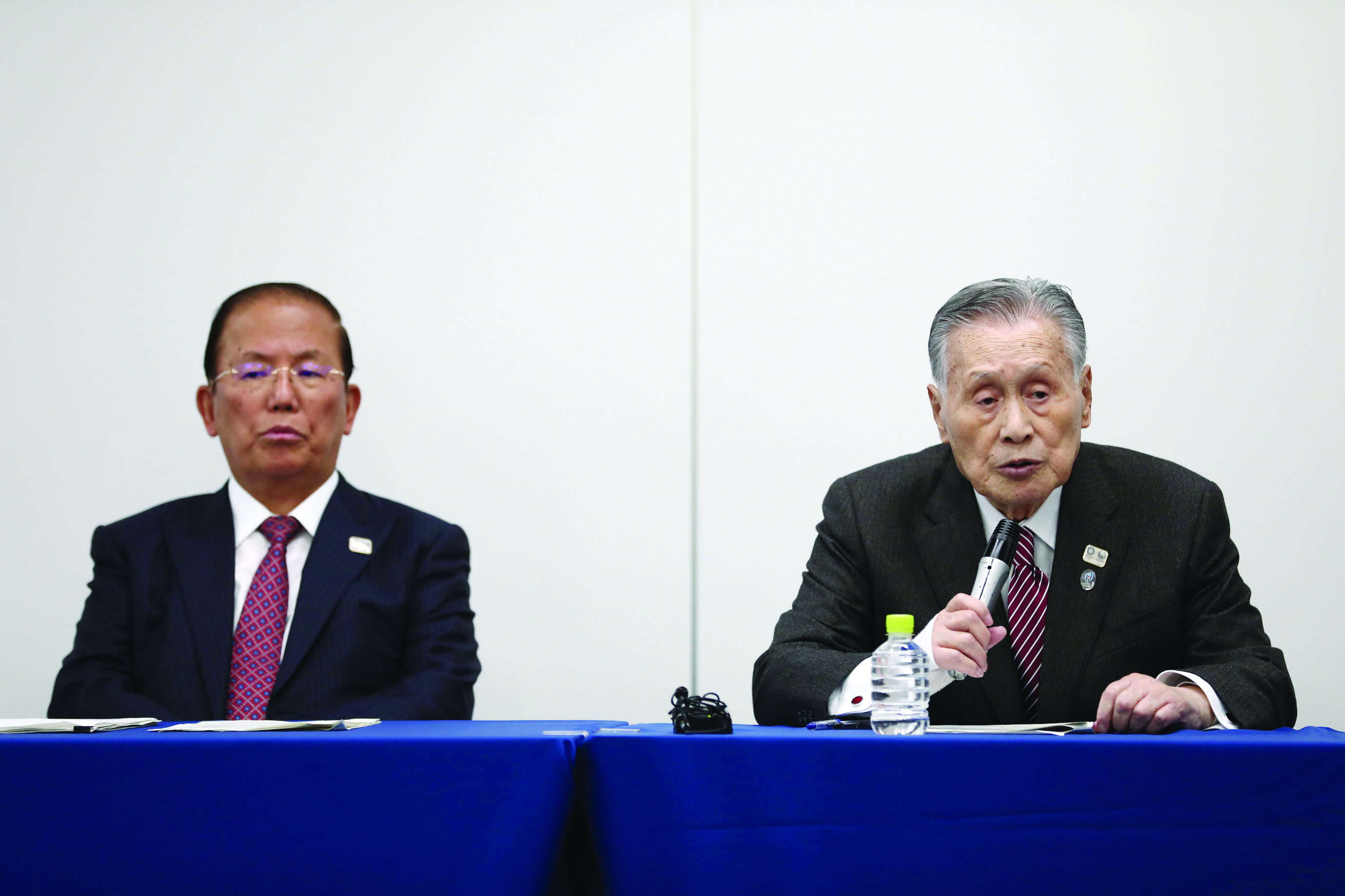 Chief executive officer of the Tokyo 2020 Olympics, Toshiro Muto (L), and Tokyo 2020 president Yoshiro Mori (R) attend a press conference in Tokyo on March 23, 2020. (Photo by Behrouz MEHRI / AFP)