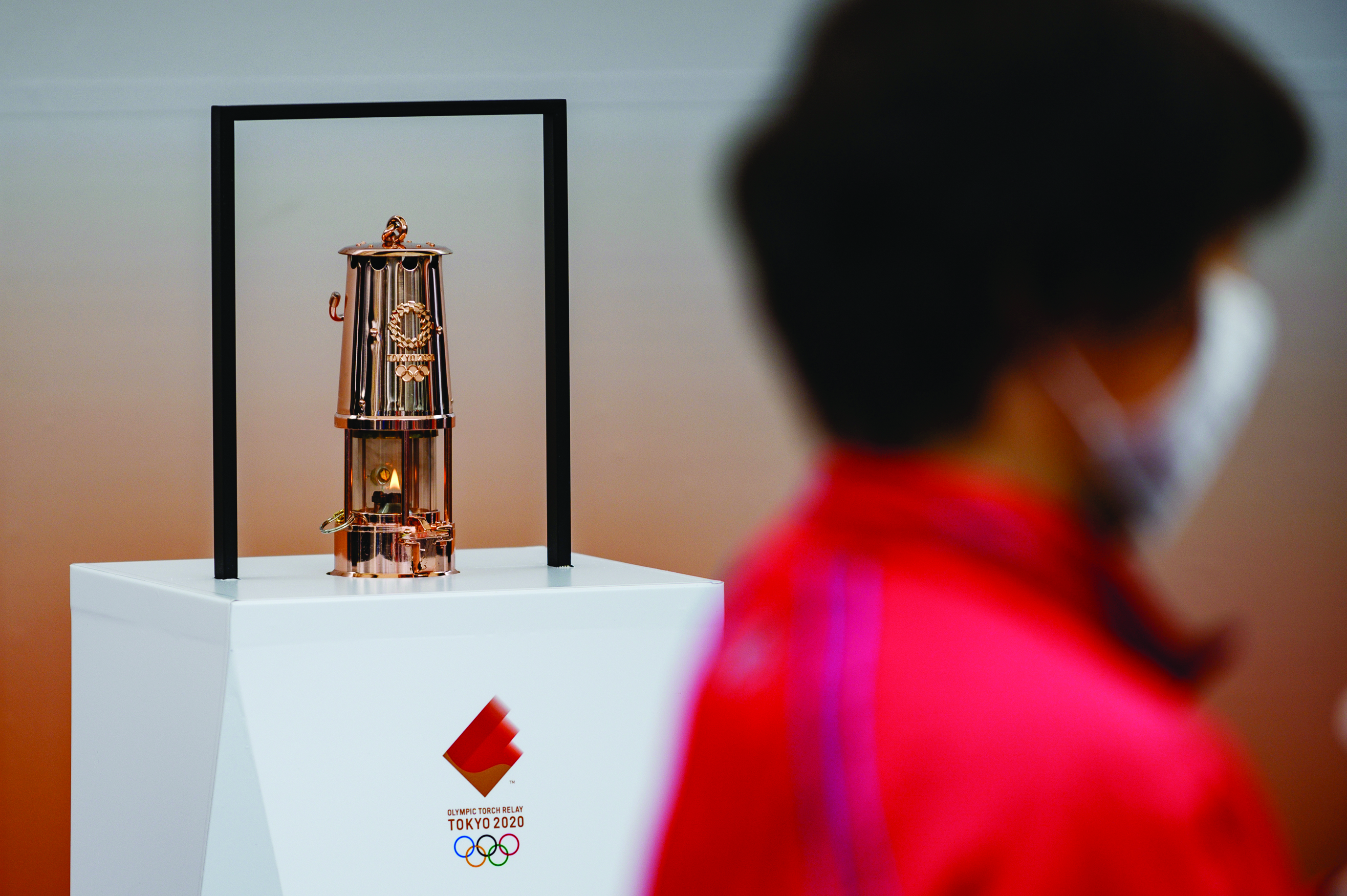 The Tokyo 2020 Olympic flame is displayed outside the railway station in Tono, Iwate prefecture on March 22, 2020. - The flame arrived in Japan to a scaled-down welcoming ceremony on March 20 as doubts grew over whether the 2020 Tokyo Olympics will go ahead on schedule as the deadly COVID-19 coronavirus causes chaos around the world. (Photo by Philip FONG / AFP)