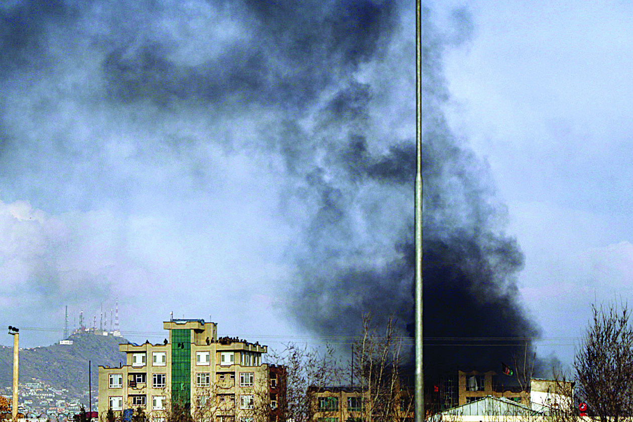 Smoke rises from the site of a gun attack following an attack during an event to mark the 25th anniversary of death of Shiite leader Abdul Ali Mazari, In Kabul on March 6, 2020. - At least 27 people were killed in an attack on a political rally in Kabul on March 6, officials said, in the deadliest assault in Afghanistan since the US signed a withdrawal deal with the Taliban. (Photo by STR / AFP)