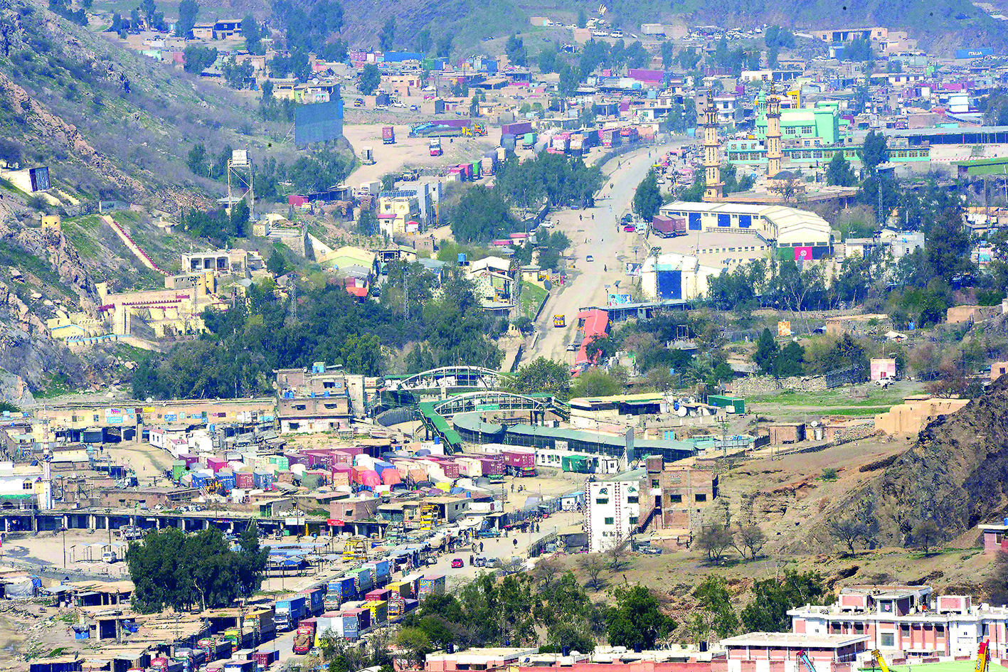 Afhan trucks line up as they wait to cross the Pakistan-Afghanistan closed amid concerns over the spread of the COVID-19 novel coronavirus, in Torkham some 54 kms fron Peshawar on March 16, 2020. - Pakistan will close its border with Iran and Afghanistan in a bid to control the spread of the coronavirus, the interior ministry said. The move is the latest such action as countries around the world act swiftly to restrict travel in an attempt to slow the global outbreak, which was this week declared a pandemic. (Photo by Abdul MAJEED / AFP)