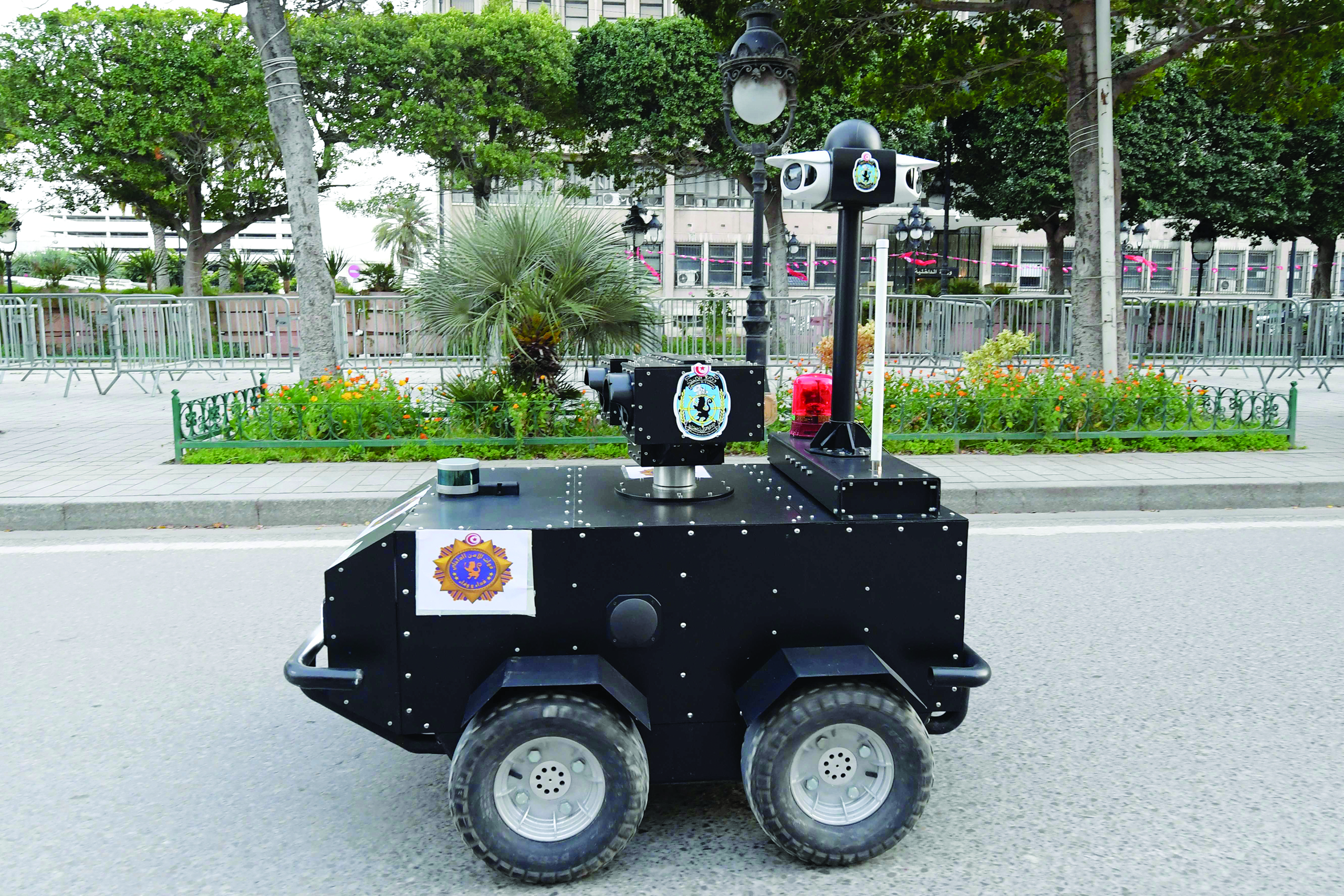A Tunisian police robot patrols along Avenue Habib Bourguiba in the centre of the capital Tunis on April 1, 2020, as a means of enforcing a nationwide lockdown to combat the COVID-19 coronavirus pandemic. - The locally-built robots are remotely operated and equipped with infrared and thermal imaging cameras, in addition to a sound and light alarm system. (Photo by FETHI BELAID / AFP)