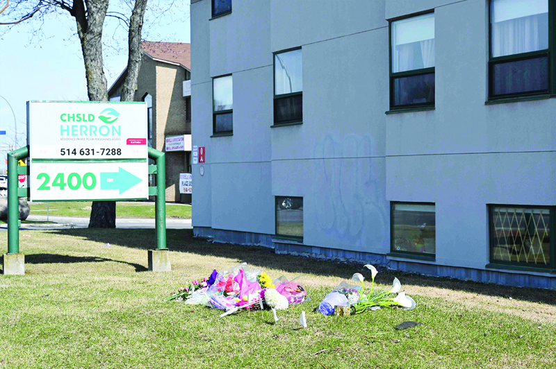 This photo taken on April 16, 2020 shows flowers outside the Herron private nursing home in Dorval, west of Montreal. - The discovery of 31 deaths at Montreal's Herron nursing home has prompted an investigation into alleged gross negligence after caregivers fled amid a coronavirus outbreak, leaving elderly residents to fend for themselves. (Photo by Eric THOMAS / AFP)