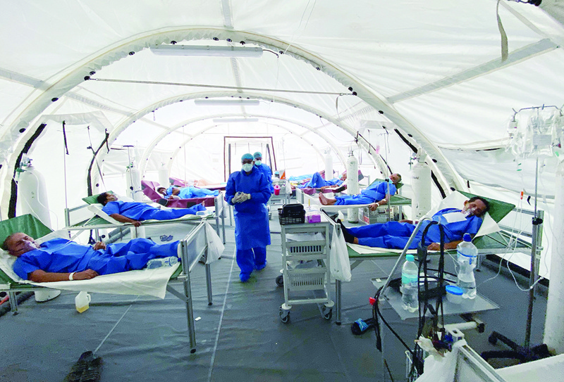 View of patients being treated for COVID-19, at the field hospital of the IESS Hospital Los Ceibos in Guayaquil, Ecuador, on April 13, 2020 during the novel coronavirus pandemic. - With hundreds of bodies left decaying in homes for days due to lack of space in the city's overwhelmed morgues and hospitals, the coronavirus has struck a blow to Ecuador's economic capital Quayaquil, now a symbol of the chaos the pandemic can unleash among Latin America's poor. (Photo by Enrique Ortiz / AFP)