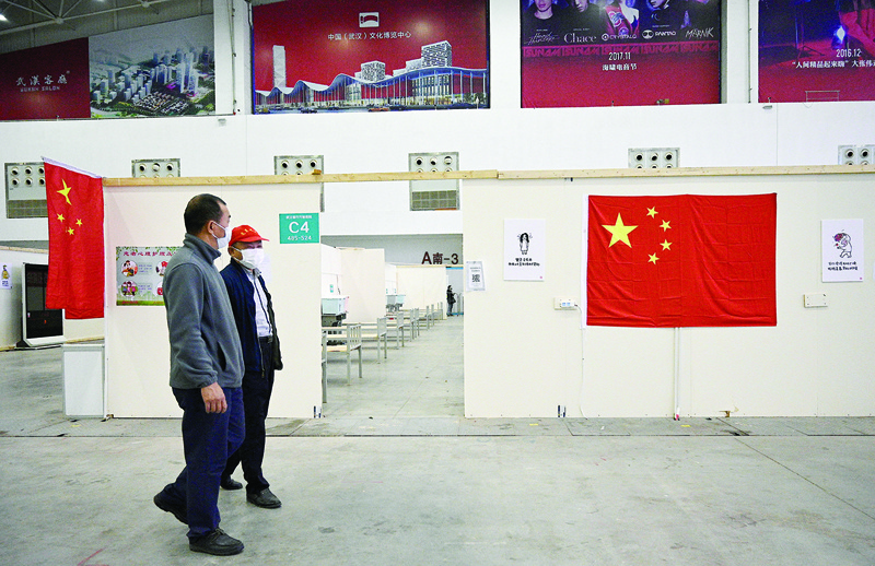 Security personnel walks inside a field hospital that had offered beds for coronavirus patients during the height of the crisis in Wuhan in Chinaís central Hubei province on April 9, 2020. - Thousands of relieved citizens streamed out of China's Wuhan on April 8 after authorities lifted months of lockdown at the coronavirus epicentre, offering some hope to the world despite record deaths in Europe and the United States. (Photo by Noel Celis / AFP)