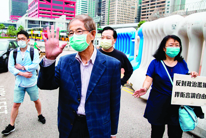 CORRECTION - Former lawmaker and pro-democracy activist Martin Lee (C) gestures as he leaves the Central District police station in Hong Kong on April 18, 2020, after being arrested and accused of organising and taking part in an unlawful assembly in August last year. - Police in Hong Kong carried out a sweeping operation against high-profile democracy campaigners on April 18, arresting 14 activists on charges related to massive protests that rocked the Asian financial hub last year. (Photo by ISAAC LAWRENCE / AFP) / ìThe erroneous mention[s] appearing in the metadata of this photo by ISAAC LAWRENCE has been modified in AFP systems in the following manner: [August] instead of [August and October]. Please immediately remove the erroneous mention[s] from all your online services and delete it (them) from your servers. If you have been authorized by AFP to distribute it (them) to third parties, please ensure that the same actions are carried out by them. Failure to promptly comply with these instructions will entail liability on your part for any continued or post notification usage. Therefore we thank you very much for all your attention and prompt action. We are sorry for the inconvenience this notification may cause and remain at your disposal for any further information you may require.î