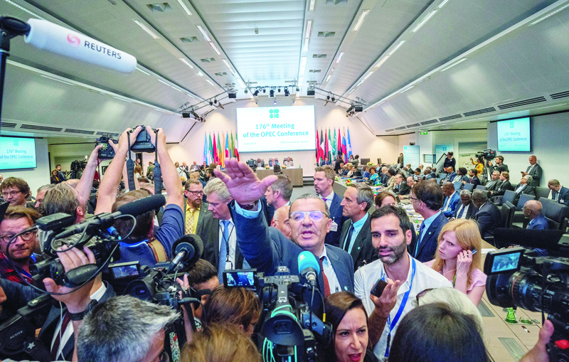 (FILES) In this file photo taken on July 01, 2019 Journalists attend the 176th meeting of the Organization of the Petroleum Exporting Countries (OPEC) conference and the 6th meeting of the OPEC and non-OPEC countries on July 1, 2019 in Vienna, Austria. - OPEC and allies will discuss on April 9, 2020 a possible output cut, faced with an oil market collapse that was fuelled by coronavirus-ravaged demand and a vicious price war. The emergency video conference, delayed from Monday, comes after US President Donald Trump claimed key producers Russia and Saudi Arabia -- which have been locked in a price war -- would agree to slash production to defend tumbling crude futures. (Photo by JOE KLAMAR / AFP)