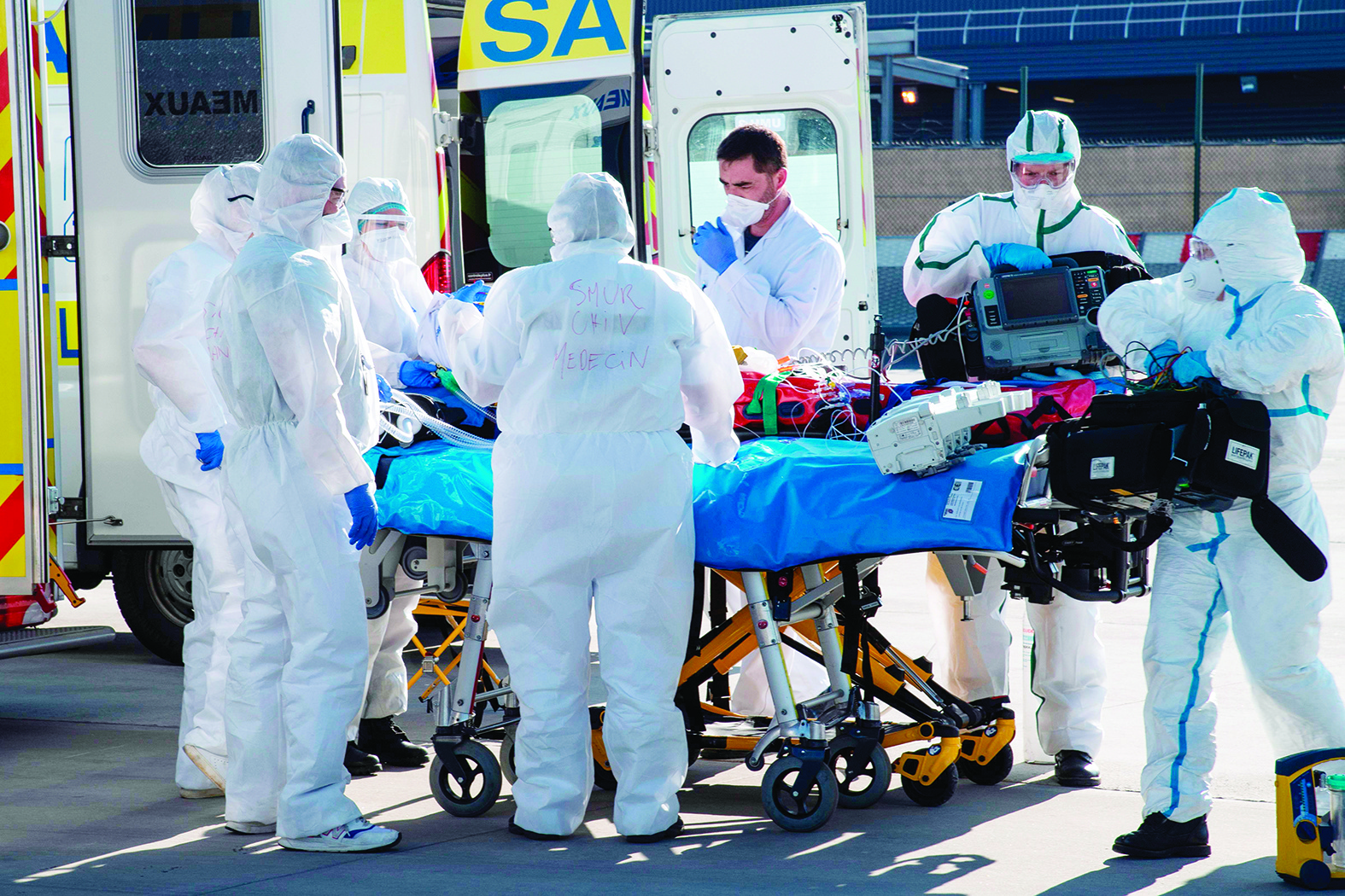 Medical staff load a patient infected with novel coronavirus, Covid-19, into a military A400M plane for transportation from Orly airport, south of the capital, to a hospital outside of the Paris region, on April 4, 2020.nnnnnnnPeople ride abike in the Montmartre district in Paris, on April 1, 2020, on the sixteenth day of a strict lockdown in France to stop the spread of COVID-19 (novel coronavirus). nBERTRAND GUAY / AFPnBERTRAND GUAY / AFP - Orly airport, now closed to travellers, has been turned into an evacuation hub as part of an operation aiming at relieving hospitals in the Paris region, hardly hit by the Covid-19 outbreak caused by the novel coronavirus. (Photo by BERTRAND GUAY / AFP)