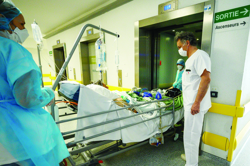 TOPSHOT - A patient infected with COVID-19 is transferred back to intensive care from an especially created Post Resuscitation Unit (UnitÈ Post RÈanimation Respiratoire) after his condition went worse on April 17, 2020 at the Emile Muller hospital in Mulhouse, eastern France, as France is on the 32nd day of a strict lockdown aimed at curbing the spread of the COVID-19 pandemic caused by the novel coronavirus. (Photo by PATRICK HERTZOG / AFP)