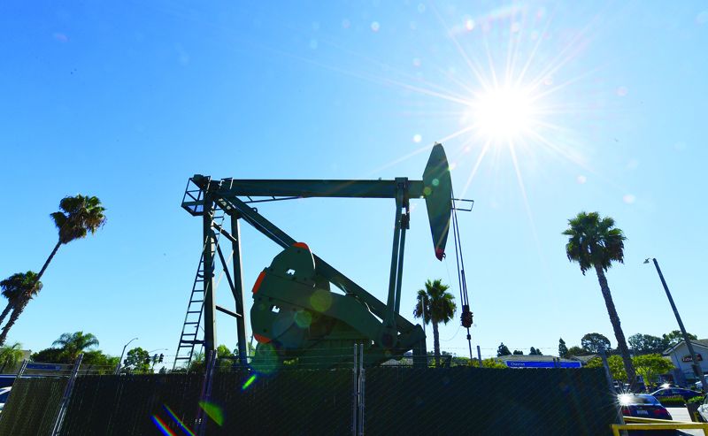 (FILES) In this file photo taken on October 21, 2019 a pumpjack from California-based energy company Signal Hill Petroleum is seen in front of the landmark Curley's Cafe, one of two pumpjacks in the Diner's parking lot which has been churning out oil from the ground below since 1921 in Signal Hill, California. - Oil prices soared more than four percent on January 3, 2020 and equities reversed early gains following news that the US had killed a top Iranian general, fanning fresh fears of a conflict in the crude-rich region. (Photo by Frederic J. BROWN / AFP)