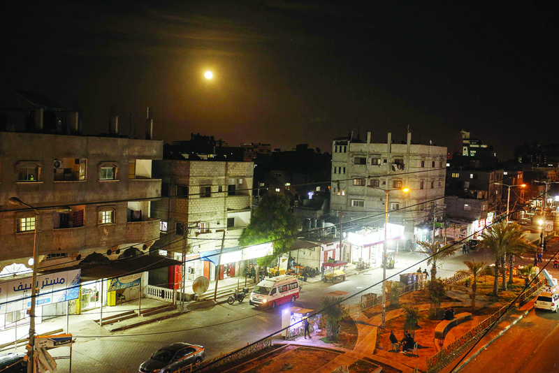 A full moon is pictured in the sky over Rafah town in the southern Gaza Strip on April 8, 2020. (Photo by SAID KHATIB / AFP)