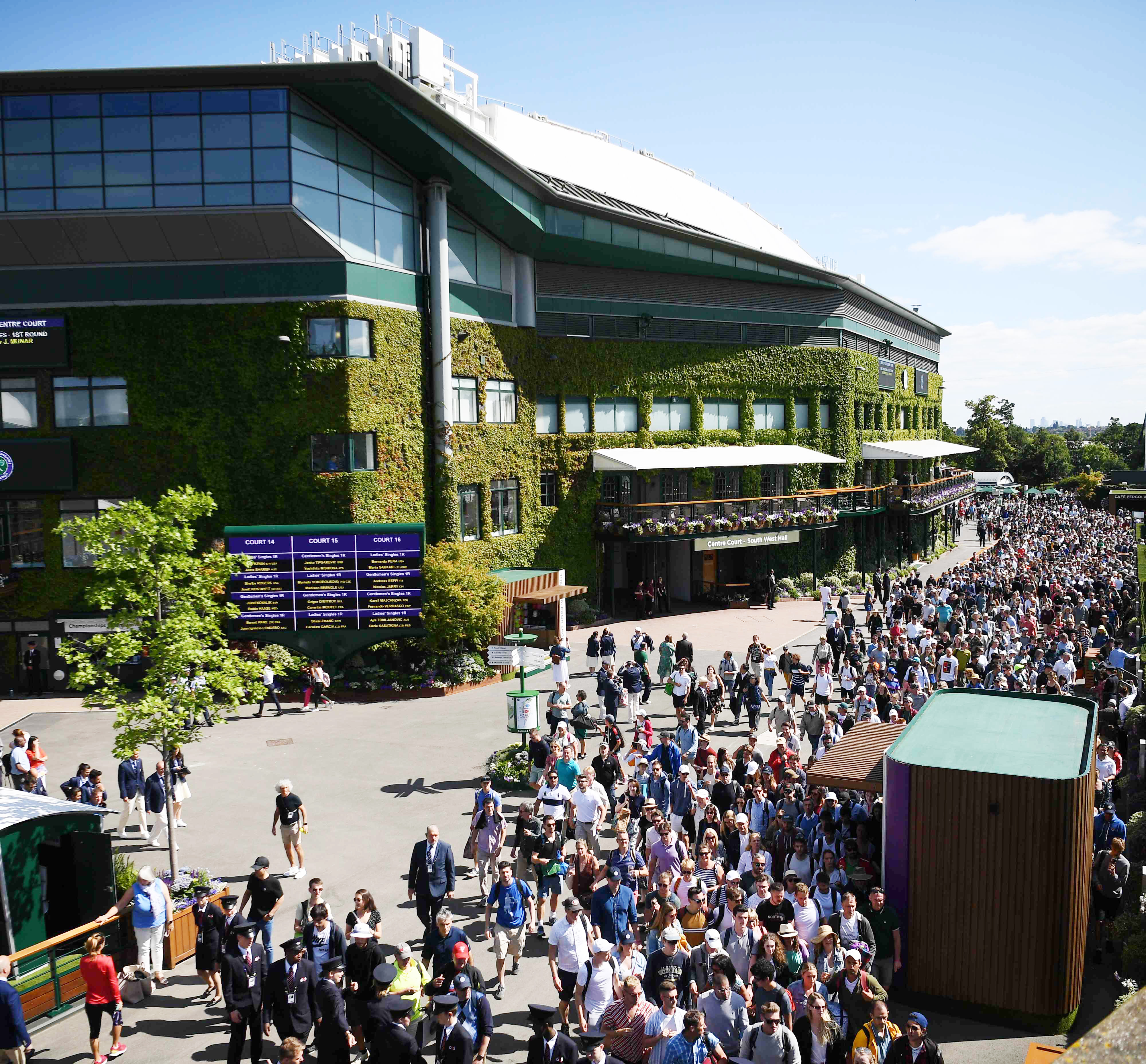 (FILES) In this file photo taken on July 01, 2019 Spectators enter The All England Tennis Club in Wimbledon, southwest London, on July 1, 2019, on the first day of the 2019 Wimbledon Championships tennis tournament. - The 2020 Wimbledon Championships has been cancelled for the first time since World War II due to the coronavirus pandemic, the organisers said in a statement on April 1, 2020, as the virus wreaks further havoc on the global sporting calendar. (Photo by Daniel LEAL-OLIVAS / AFP) / RESTRICTED TO EDITORIAL USE