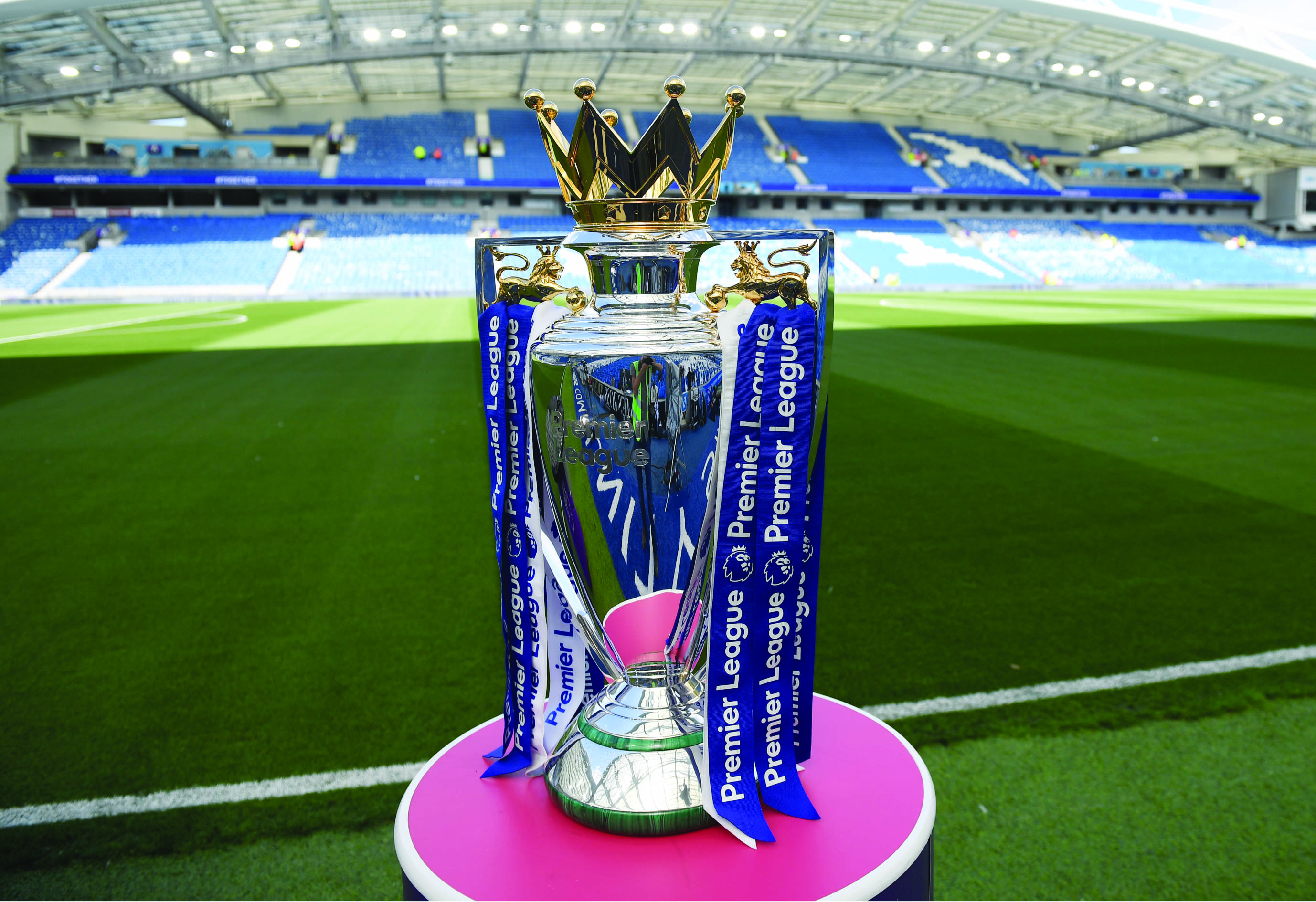 (FILES) In this file photo taken on August 12, 2017 The Premier league trophy sits beside the pitch ahead of the English Premier League football match between Brighton and Hove Albion and Manchester City at the American Express Community Stadium in Brighton. - Premier League clubs will ask players to take a combination of pay cuts and deferrals amounting to 30 percent of their salary due to the financial crisis caused by coronavirus, the league said in a statement on April 3, 2020. (Photo by CHRIS J RATCLIFFE / AFP) / RESTRICTED TO EDITORIAL USE. No use with unauthorized audio, video, data, fixture lists, club/league logos or 'live' services. Online in-match use limited to 75 images, no video emulation. No use in betting, games or single club/league/player publications. /