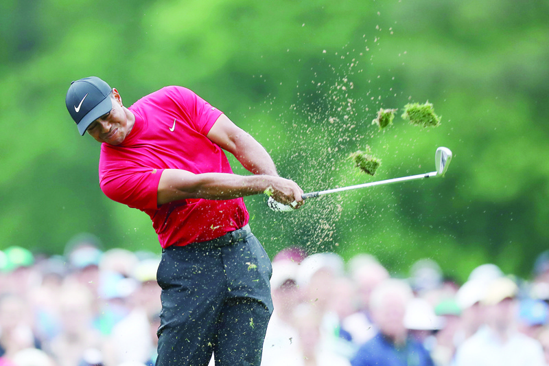 (FILES) In this file photo Tiger Woods of the United States plays a shot from the 12th tee during the final round of the Masters at Augusta National Golf Club on April 14, 2019 in Augusta, Georgia. - Reigning Masters champion Tiger Woods had a relaxed dinner with loved ones on April 7, 2020 instead of the Masters Champions Dinner he was once scheduled to host Tuesday at Augusta National. The Masters has been postponed to November by the coronavirus pandemic, with Woods, a 15-time major winner and five-time Masters champion, among those staying home to try and slow the spread of the deadly virus. (Photo by DAVID CANNON / GETTY IMAGES NORTH AMERICA / AFP)
