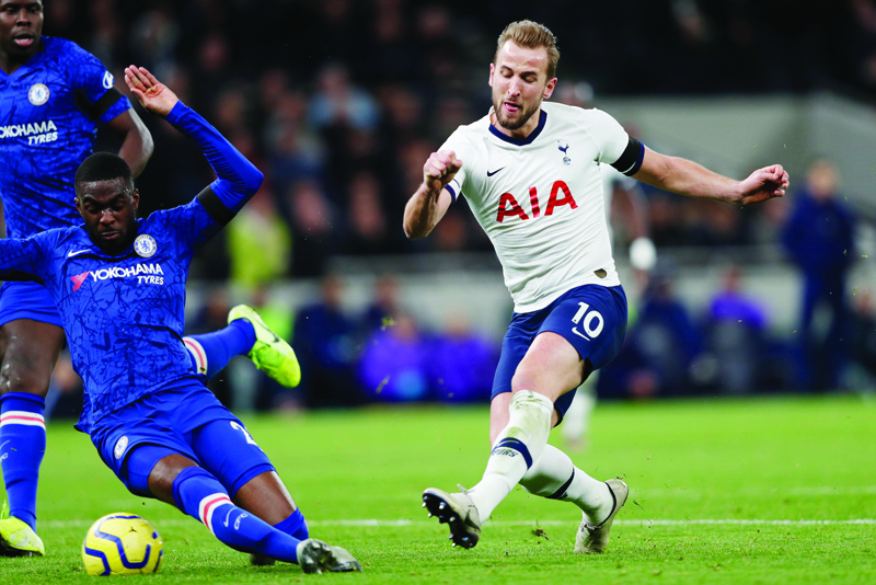 (FILES) In this file photo taken on December 22, 2019 Tottenham Hotspur's English striker Harry Kane has an unsuccessful shot during the English Premier League football match between Tottenham Hotspur and Chelsea at Tottenham Hotspur Stadium in London - Former Manchester United captain Gary Neville believes the Premier League may force clubs who are looking to cut player wages during the coronavirus crisis to accept transfer embargoes. (Photo by Adrian DENNIS / AFP) / RESTRICTED TO EDITORIAL USE. No use with unauthorized audio, video, data, fixture lists, club/league logos or 'live' services. Online in-match use limited to 120 images. An additional 40 images may be used in extra time. No video emulation. Social media in-match use limited to 120 images. An additional 40 images may be used in extra time. No use in betting publications, games or single club/league/player publications. /