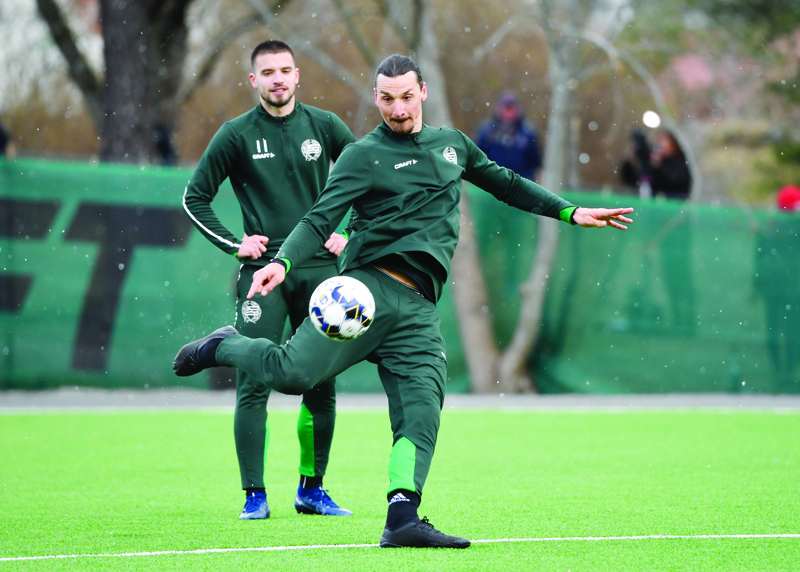 AC Milan's Swedish forward Zlatan Ibrahimovic (R) attends a training session of Swedish league team Hammarby IF at Arsta IP on April 13, 2020 in Stockholm. (Photo by Henrik MONTGOMERY / TT News Agency / AFP) / Sweden OUT
