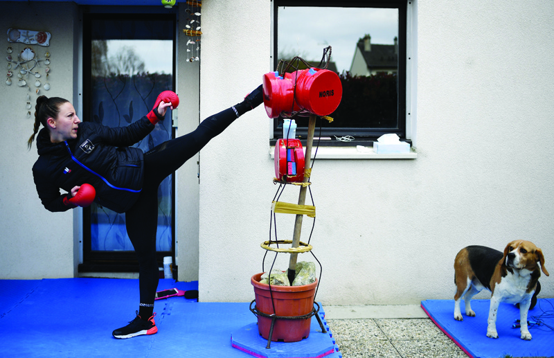 Alexandra Recchia of France, five-time karate world champion, trains in the garden of her house on April 3, 2020, in L'Hay-les-Roses, near Paris, on the 18th day of a lockdown in France aimed at curbing the spread of the COVID-19 (novel coronavirus). (Photo by FRANCK FIFE / AFP)