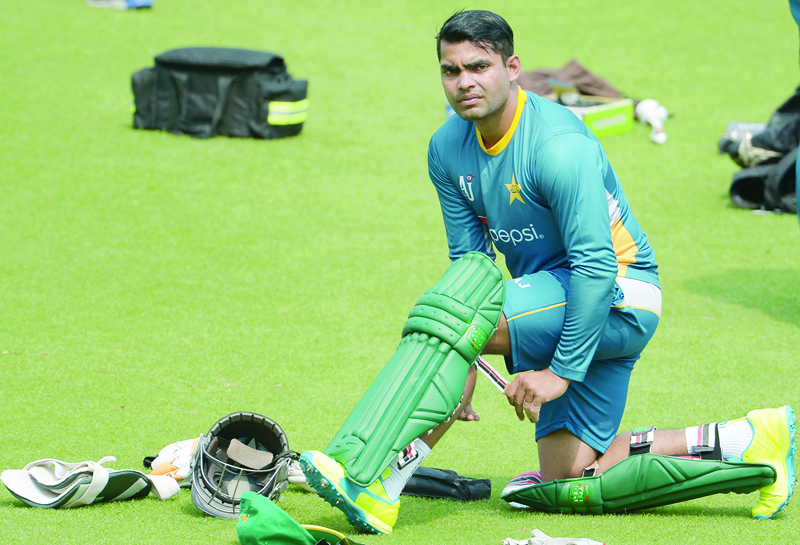 (FILES) In this file photo taken on March 13, 2016 Pakistan's Umar Akmal pads up as he takes part in a training session ahead of the World T20 cricket tournament match at The Eden Gardens Cricket Stadium in Kolkata. - Akmal has been banned from all forms of cricket for three years for failing to report spot-fixing offers, the Pakistan Cricket Board announced on April 27, 2020. Umar, who turns 30 next month, pleaded guilty to not reporting the fixing offers which led to his provisional suspension on February 20 this year. (Photo by Dibyangshu SARKAR / AFP)