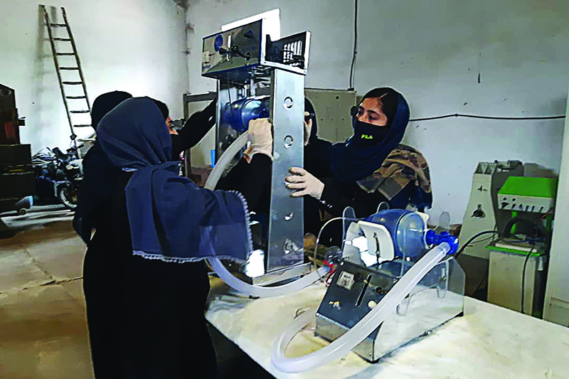 In this photograph taken on April 8, 2020, workers of an  all-female robotic team build a ventilator in preparation for COVID-19 coronavirus patients, at a workshop, in Herat. - A team of robot-designing girls in Afghanistan is trying to build a low-cost medical ventilator from car parts, as health authorities look to boost critical-care capabilities for coronavirus patients in the impoverished country. If the teenagers succeed and can get government approval for their prototype, they say it could be replicated for as little as $300, where normally ventilators sell for around $30,000. (Photo by Ahmad Idres Naderi / AFP)