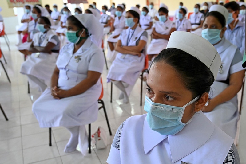 Nurses take part in a ceremony to mark International Nurses Day, celebrated on the birthday of Florence Nightingale, in Colombo on May 12, 2020. - AFP