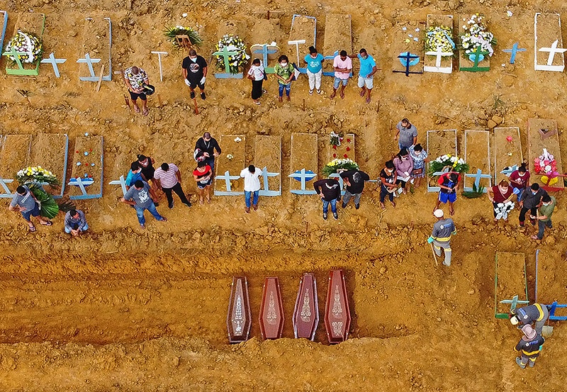 MANAUS: This file aerial picture shows a burial taking place at an area where new graves have been dug up at the Nossa Senhora Aparecida cemetery in Manaus, in the Amazon forest in Brazil, during the COVID-19 coronavirus pandemic. - AFP