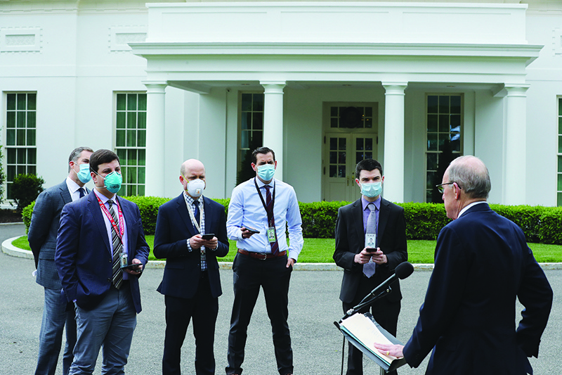 WASHINGTON, DC:  White House Economic Council Director Larry Kudlow talks to reporters wearing face masks outside the White House on the morning that the Labor Department announced that more than 20 million people lost their jobs in April due to the novel coronavirus pandemic  in Washington, DC. —AFP