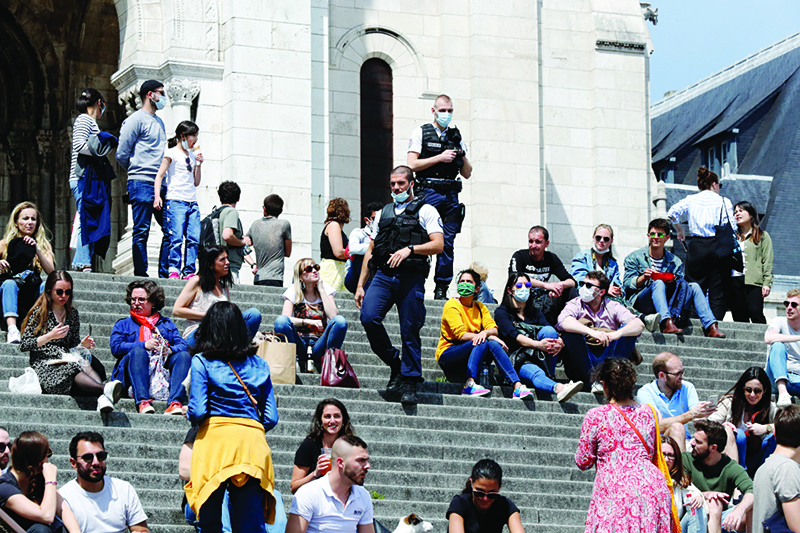 PARIS: French policemen disperse people sitting on the stairs in front of Le Sacre Coeur in Paris on the first weekend after France eased lockdown measures taken to curb the spread of the COVID-19 pandemic.- AFP