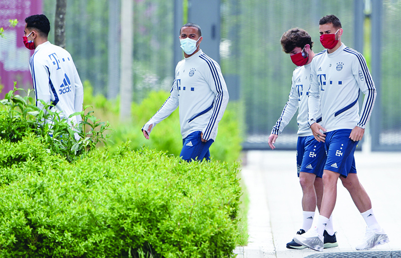 (L-R) French midfielder Corentin Tolisso, Spanish midfielder Thiago Alcantara, Spanish defender Alvaro Odriozola and French defender Lucas Hernandez wear face masks as they arrive for a training session of the German first division Bundesliga football club FC Bayern Munich on May 13, 2020 at the Bayern's campus in Munich, southern Germany. The Bundesliga returns on May 16, 2020 with Bayern facing Union Berlin on May 17 in an empty stadium due to the new coronavirus pandemic.nChristof STACHE / AFP