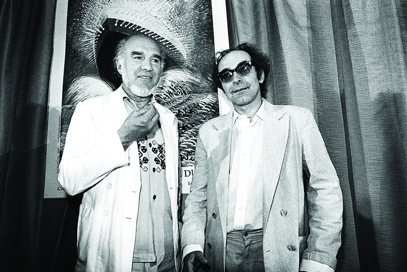 In this file photo taken on May 24, 1982, French actor Michel Piccoli (left) and French filmmaker Jean-Luc Godard pose prior to the screening of “Passion” during a Cannes film festival.
