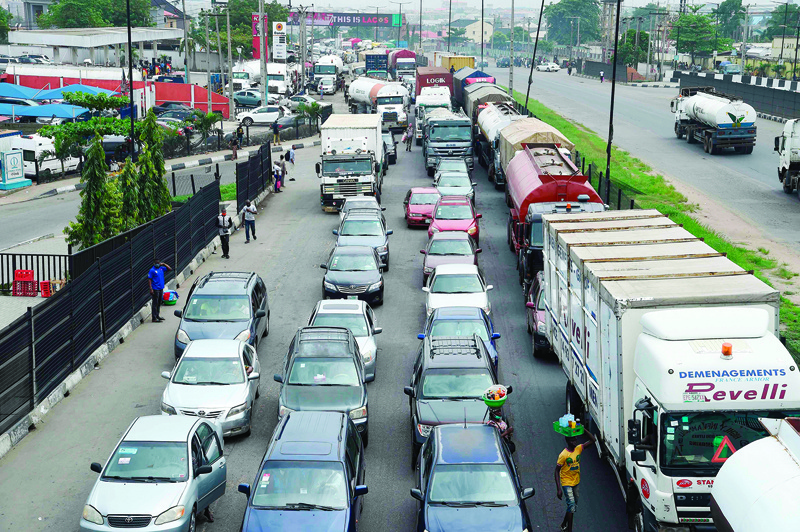 Motorists queue in a traffic gridlock as commercial activities return at the end of a five-week COVID-19 coronavirus lockdown in Lagos, on May 4, 2020. - In the metropolis of 20 million, where exuberance and poverty live side by side, relief at being able to earn money once again was almost palpable, despite Nigeria's mounting COVID-19 coronavirus toll. (Photo by PIUS UTOMI EKPEI / AFP)