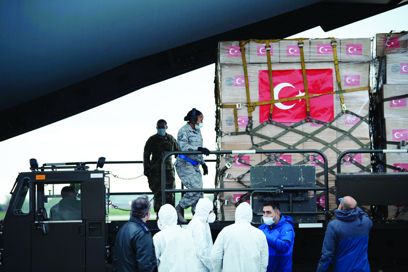 (FILES) In this file photo taken on April 28, 2020 A Turkish military cargo plane with medical supplies and protective equipment to combat COVID-19 in the US is unloaded at Andrews Air Force Base, in Maryland. - The United States has long hailed its aid overseas as a sign of good intentions, but friends and foes alike are seeing opportunities of their own by helping the global power ravaged by the coronavirus. Turkey, looking to end a rough spell with its NATO ally, and Egypt, whose autocratic leader counts on support from President Donald Trump, both sent military jets full of supplies in the past two weeks, while Taiwan, reliant on Washington for its defense and praised for its effective coronavirus response, has sent millions of masks. (Photo by Brendan Smialowski / AFP)