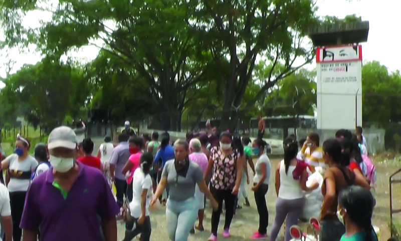 Video grab of relatives of inmates reacting outside Los Llanos prison, in Guanare, Portuguesa state, Venezuela on May 2, 2020, after a riot occured. - The death toll from a prison riot in western Venezuela has risen to at least 47, with 75 wounded, an opposition politician and prisoners' rights group said Saturday. With the coronavirus pandemic raging, visits from family and friends -- who often bring food and medicine to inmates -- have been greatly reduced. (Photo by Pedro UGARTE / AFPTV / AFP) / BEST QUALITY AVAILABLE