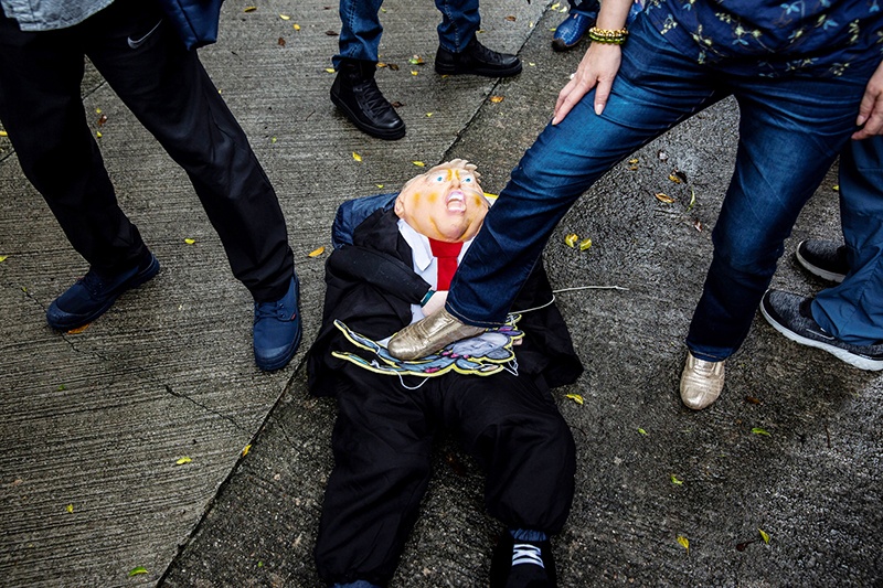 HONG KONG: A pro-China activist steps on an effigy of US President Donald Trump during a protest outside the US consulate in Hong Kong in response to US President Donald Trump saying he would strip several of Hong Kong’s special privileges with the United States and bar some Chinese students from US universities in anger over Beijing’s bid to exert control in the financial hub.— AFP