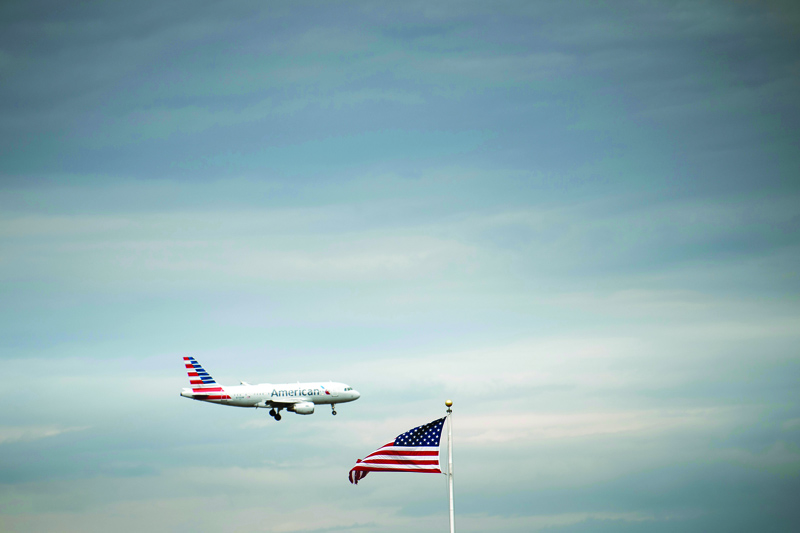(FILES) In this file photo taken on May 9, 2019 an American Airlines passenger jet approaches Ronald Reagan Washington National Airport, in Arlington, Virginia. - Wall Street stocks tumbled in early trading May 4, 2020, with airline shares taking a major hit after Warren Buffett said he liquidated his holdings in major US carriers. About 15 minutes into trading, the Dow Jones Industrial Average stood at 23,383.10, down 1.4 percent.The broad-based S&amp;P 500 dropped 1.0 percent to 2,801.24, while the tech-rich Nasdaq Composite Index shed 0.6 percent to 8,558.01. (Photo by Brendan Smialowski / AFP)