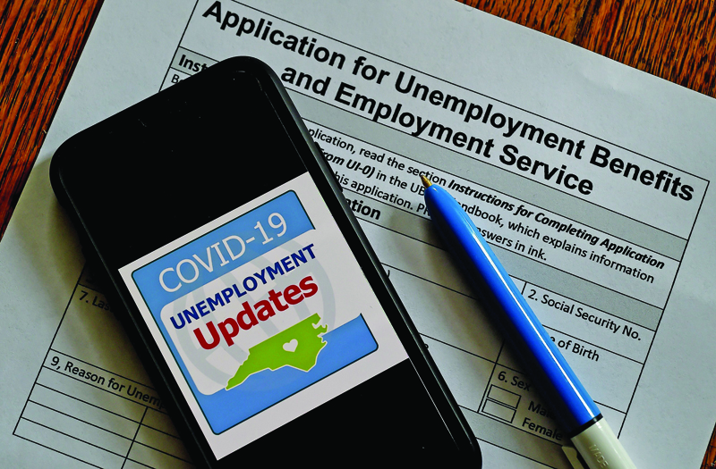 In this photo illustration, a COVID-19 Unemployment Assistance Updates logo is displayed on a smartphone on top of an application for unemployment benefits on May 8, 2020, in Arlington, Virginia. - With shops and factories closed nationwide due to the coronavirus pandemic, nearly all of the jobs created in the US economy in the last decade were wiped out in a single month. An unprecedented 20.5 million jobs were destroyed in April in the world's largest economy, driving the unemployment rate to 14.7 percent compared to 4.4 percent in March, the Labor Department said in its monthly report, the first to capture the impact of a full month of the lockdowns. (Photo by Olivier DOULIERY / AFP)