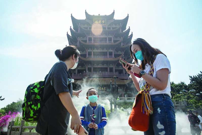 People visit Yellow Crane Tower after it reopened to the public in Wuhan in China's central Hubei province on April 29, 2020. - China has largely brought the coronavirus under control within its borders since the outbreak first emerged in the city of Wuhan late last year. (Photo by STR / AFP) / China OUT