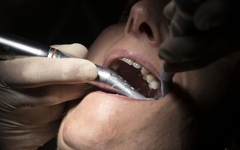 A dentist wearing protective equipment treats a patient in Guebwiller, eastern France. – AFP
