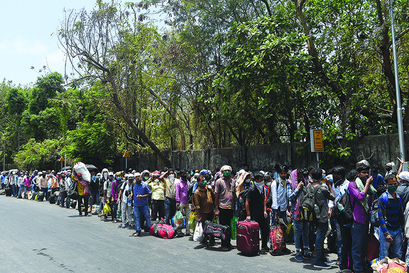 MUMBAI: Migrant workers queue outside the CST railway station to return to their hometowns yesterday after the government eased a nationwide lockdown. – AFP