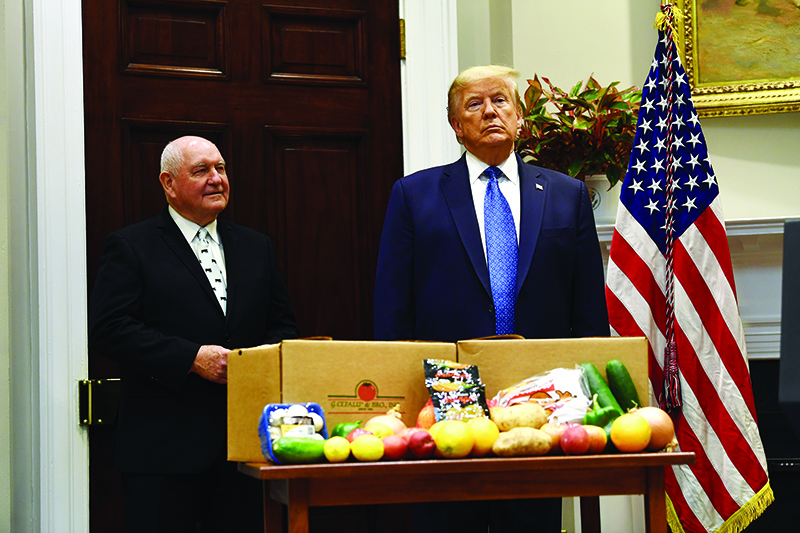 WASHINGTON: US President Donald Trump and Agriculture Secretary Sonny Perdue attend an event about the food supply chain during the coronavirus pandemic in the Roosevelt Room of the White House on Tuesday. – AFP