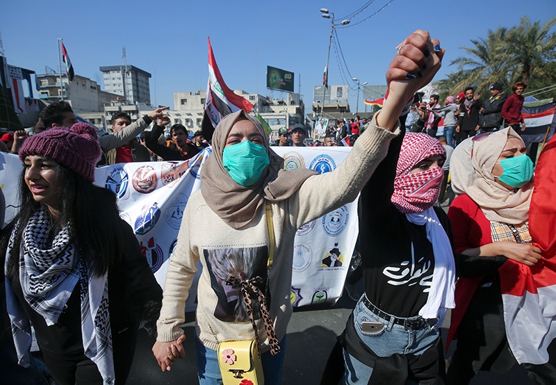 BAGHDAD: In this file photo taken on Feb 4, 2020, Iraqi students hold hands and chant as they march in an anti-government demonstration in Tahrir Square. – AFP