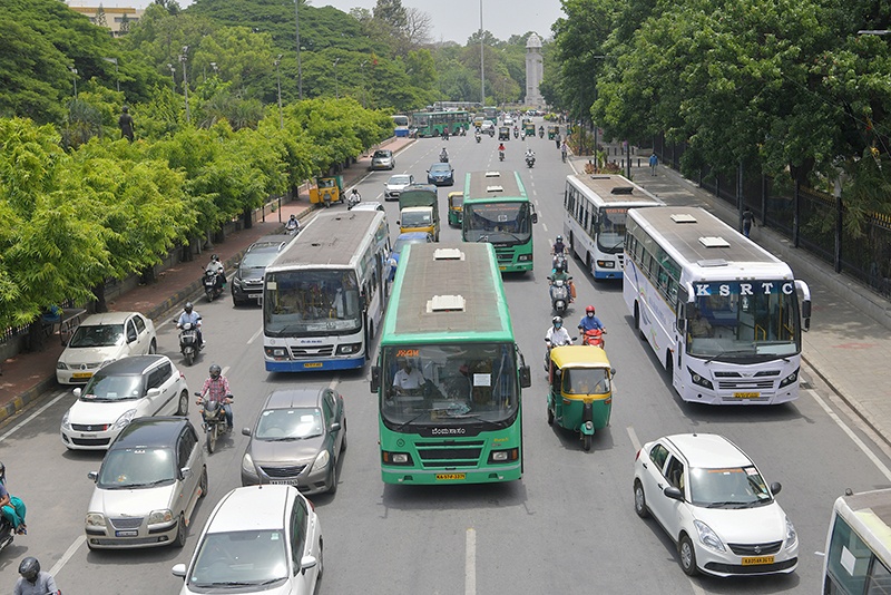 BANGALORE: Commuters and Bangalore Metropolitan Transport Corporation (BMTC) buses drive along a road as bus services resume after the government eased a nationwide lockdown against the spread of COVID-19 coronavirus in Bangalore. —AFP