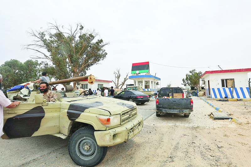Vehicles of forces loyal to Libya's UN-recognized Government of National Accord (GNA) are seen outside a checkpoint at Al-Watiya airbase also known as Okba Ibn Nafa airbase, which they seized control of, southwest of the capital Tripoli. – AFP