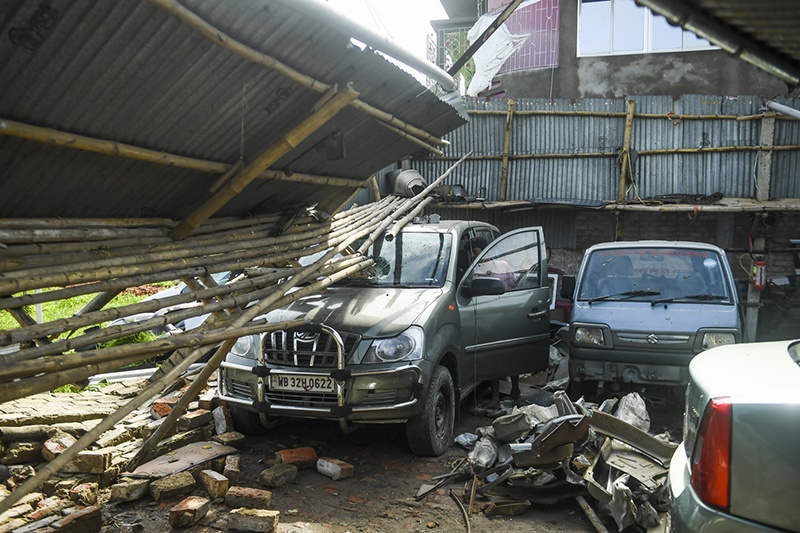SATKHIRA: A man checks cars in a garage damaged by cyclone Amphan in Satkhira. - AFP
