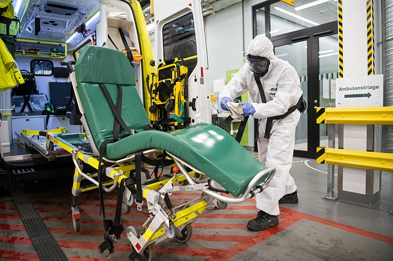 A healthcare worker cleans and disinfects an ambulance after dropping a patient at the Intensive Care Unit (ICU) at Danderyd Hospital near Stockholm during the coronavirus COVID-19 pandemic. - AFP