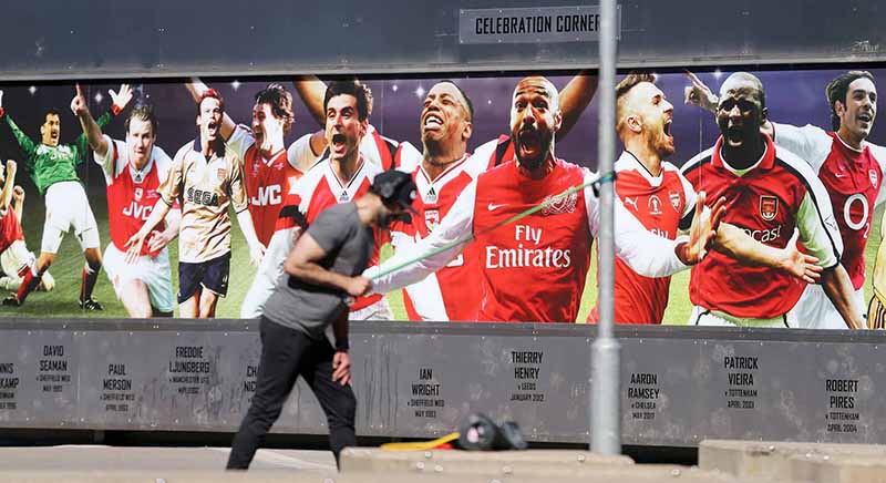 LONDON: A man exercises outside the Emirates stadium, the home ground of English Premier League football team Arsenal, in north London on May 19, 2020, as training resumes for the first time since the Premier League was halted due to the COVID-19 pandemic. – AFP