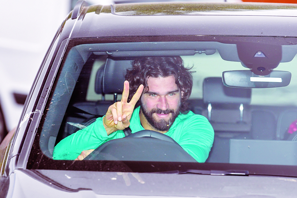 Liverpool's Brazilian goalkeeper Alisson Becker arrives at Melwood in Liverpool, north west England for a training session on May 19, 2020, as training resumes for the first time since the English Premier League was halted due to the COVID-19 pandemic. (Photo by Paul ELLIS / AFP)