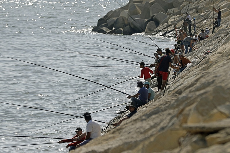 BEIRUT: Fishermen gather along Dbayeh's seaside shore, north of the Lebanese capital Beirut. - AFP
