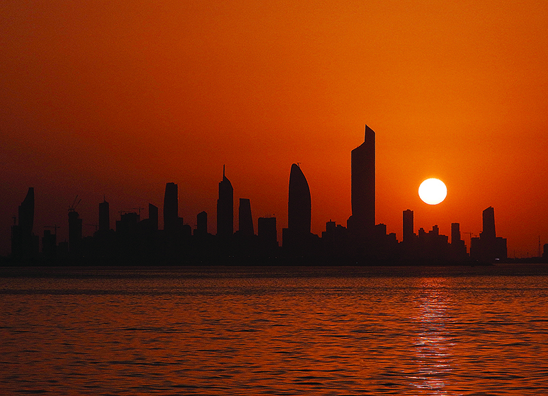 KUWAIT: The sun sets behind the skyline of Kuwait City on June 25, 2020. —Photo by Yasser Al-Zayyat