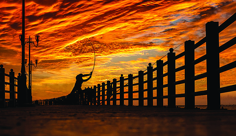 KUWAIT: A man casts his fishing rod at a beach in Kuwait City in this file photo. —KUNA