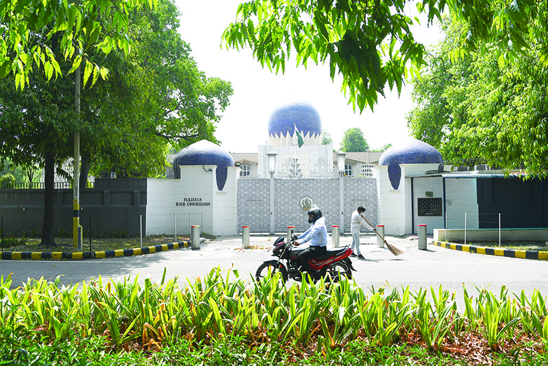 NEW DELHI: A motorist rides past the main gate of the Pakistan High Commission in New Delhi yesterday. – AFP